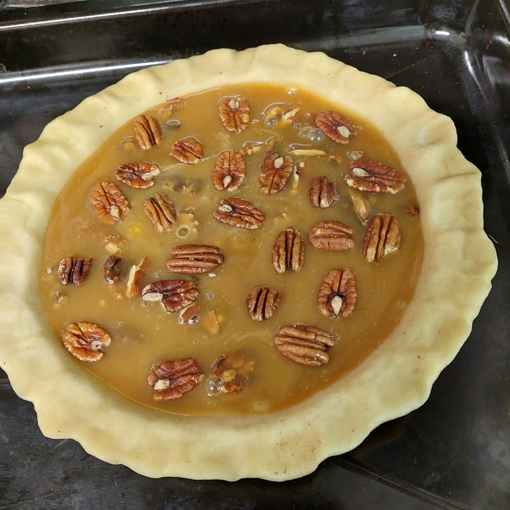 caramel pecan pie ready for baking